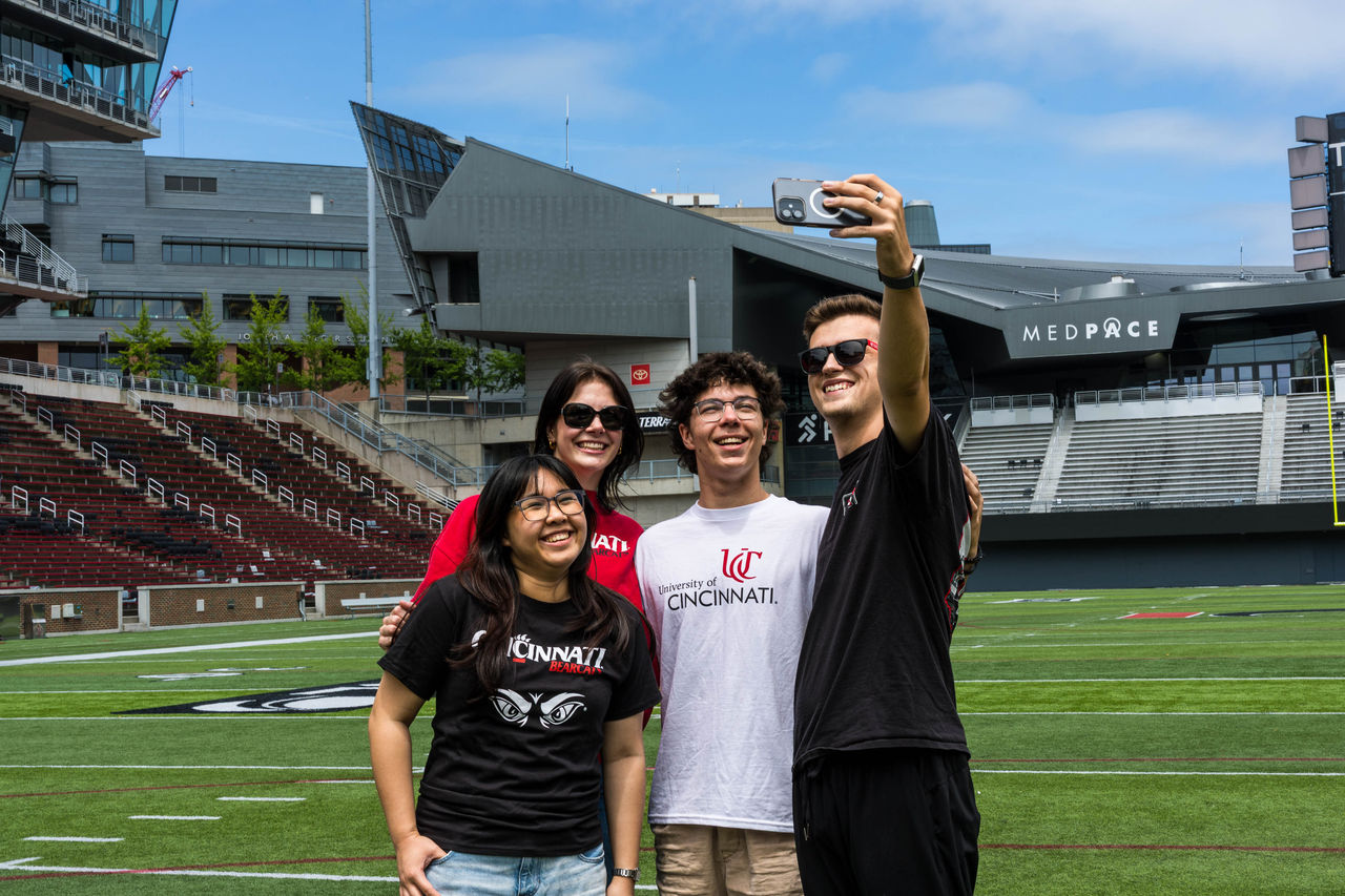 Student football fans taking selfie on Nippert field