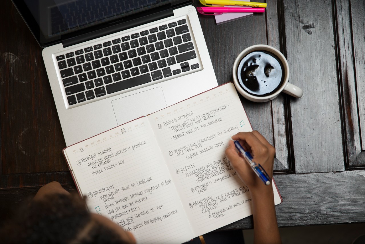 Image of a laptop and notebook