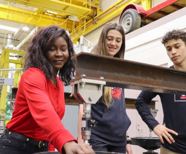 Students on laptops smiling