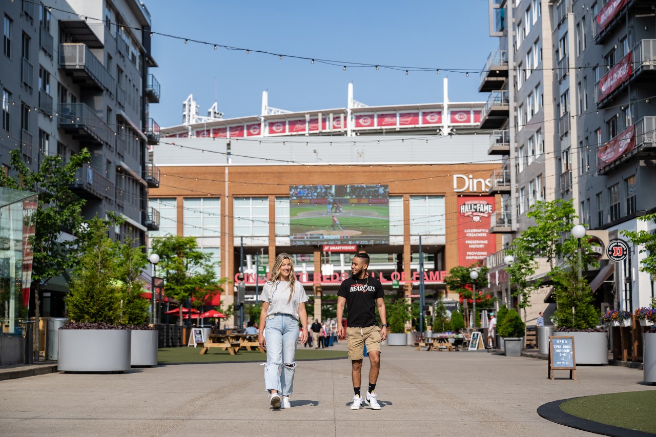 Two UC students walking in front of Great American Ballpark